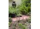Lush landscaping featuring a brick path with pink flowers and a large outdoor urn at 676 Whitehurst, Pittsboro, NC 27312