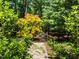 A beautiful seating area is framed by lush landscaping, creating a private outdoor sanctuary at 676 Whitehurst, Pittsboro, NC 27312