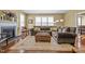 Open concept living room featuring fireplace, plush sectional sofa, and hardwood floors at 676 Whitehurst, Pittsboro, NC 27312