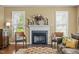 Living room area features a fireplace, two chairs, and hardwood floors at 676 Whitehurst, Pittsboro, NC 27312