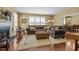 Open concept living room featuring fireplace, plush sectional sofa, and hardwood floors at 676 Whitehurst, Pittsboro, NC 27312