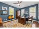 A home office features hardwood floors, two windows, a desk, musical instruments and a ceiling fan at 676 Whitehurst, Pittsboro, NC 27312
