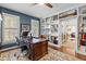 Well-lit home office with custom built-ins, desk, and hardwood floors at 676 Whitehurst, Pittsboro, NC 27312