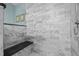 Shower with marble tile, a built-in bench, and a rainfall shower head at 676 Whitehurst, Pittsboro, NC 27312