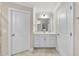 Bright bathroom with neutral tile, double sinks and a large mirror for a luxurious feel at 707 Newlyn Dr, Raleigh, NC 27606