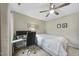 Bedroom featuring neutral walls, carpet, ceiling fan, and small desk setup with dual monitors at 707 Newlyn Dr, Raleigh, NC 27606