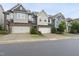 Attractive townhomes with attached garages and diverse exterior designs, set along a street at 707 Newlyn Dr, Raleigh, NC 27606
