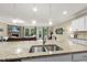 Spacious island with stone countertops and pendant lights, creating a focal point in the open layout at 707 Newlyn Dr, Raleigh, NC 27606