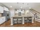 Modern kitchen with granite countertops, stainless steel appliances, white cabinetry, and wooden floors at 707 Newlyn Dr, Raleigh, NC 27606