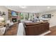 Comfortable living room with stone fireplace, brown leather sectional, and bright, natural light at 707 Newlyn Dr, Raleigh, NC 27606