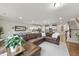 Spacious living area with a sectional sofa, fireplace, stairs, and views of the kitchen at 707 Newlyn Dr, Raleigh, NC 27606