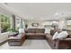 Open-concept living space featuring a large brown sectional sofa, kitchen, and dining area at 707 Newlyn Dr, Raleigh, NC 27606