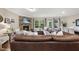 Comfortable living room with stone fireplace, brown leather sectional, and bright, natural light at 707 Newlyn Dr, Raleigh, NC 27606
