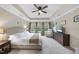Spacious main bedroom with tray ceilings, neutral carpet, a fan and a picturesque window view at 707 Newlyn Dr, Raleigh, NC 27606