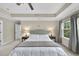 Bright main bedroom with neutral carpet, picturesque window view, and ample space for relaxation at 707 Newlyn Dr, Raleigh, NC 27606