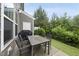 Patio area features outdoor seating, a grill, and a well-maintained fenced yard with green space at 707 Newlyn Dr, Raleigh, NC 27606