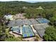 Aerial view of tennis and pickleball courts near a pool and clubhouse amidst a lush green landscape at 71012 Russell, Chapel Hill, NC 27517