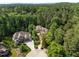 Aerial view of estate home showing mature trees, circular driveway, professionally landscaped yard and brickwork at 71012 Russell, Chapel Hill, NC 27517