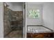 Bathroom showcasing a glass-enclosed shower and a built-in soaking tub under a bright window at 71012 Russell, Chapel Hill, NC 27517