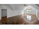 Open bonus room features hardwood floors, a ceiling fan, and a dormer window for natural light at 71012 Russell, Chapel Hill, NC 27517
