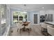 Light-filled breakfast nook with modern chandelier and large windows at 71012 Russell, Chapel Hill, NC 27517