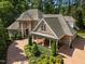 Exterior elevation of home showing brick, stone and siding, a covered porch and professional landscaping at 71012 Russell, Chapel Hill, NC 27517