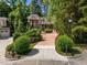 Beautiful home with landscaped front yard, a long driveway, and mature trees at 71012 Russell, Chapel Hill, NC 27517