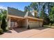Spacious three-car garage with an open covered area for parking with stone accents and a brick exterior at 71012 Russell, Chapel Hill, NC 27517