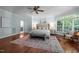Spacious main bedroom features hardwood floors, a ceiling fan, and natural light at 71012 Russell, Chapel Hill, NC 27517