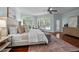 Sun-filled main bedroom boasts large windows, a cozy sitting area, and hardwood floors at 71012 Russell, Chapel Hill, NC 27517