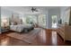 Sun-filled main bedroom boasts large windows, a cozy sitting area, and hardwood floors at 71012 Russell, Chapel Hill, NC 27517