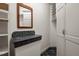 Walk-in closet with shelving and a built-in vanity area featuring a marble countertop and a wooden framed mirror at 71012 Russell, Chapel Hill, NC 27517