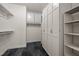 Spacious walk-in closet with built-in shelving, rods for hanging clothes, and marble floors at 71012 Russell, Chapel Hill, NC 27517