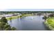 Scenic aerial view of a community lake with fountain, surrounded by trees and neighborhoods at 72 S Grey Abbey Dr, Clayton, NC 27527