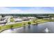 Scenic aerial view of the community featuring a lake, shopping, and neighborhood at 72 S Grey Abbey Dr, Clayton, NC 27527