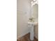 Bathroom featuring a pedestal sink with a decorative hand towel, and a round mirror at 72 S Grey Abbey Dr, Clayton, NC 27527