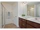 Bathroom with double sink vanity, dark wood cabinets, and glass shower doors at 72 S Grey Abbey Dr, Clayton, NC 27527