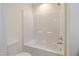 Bathroom features a white tub and toilet with tiled flooring at 72 S Grey Abbey Dr, Clayton, NC 27527