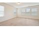 Bright bedroom with neutral carpet, multiple windows, and natural light at 72 S Grey Abbey Dr, Clayton, NC 27527