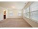 Spacious bedroom featuring neutral carpet, natural light, and view of connected bathroom at 72 S Grey Abbey Dr, Clayton, NC 27527