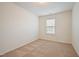 Cozy bedroom with neutral carpet, a window with blinds, and soft, neutral walls at 72 S Grey Abbey Dr, Clayton, NC 27527
