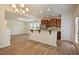 Open-concept kitchen with stainless steel appliances, granite countertops, and an eat-in bar at 72 S Grey Abbey Dr, Clayton, NC 27527