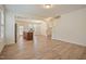 Spacious living room featuring wood-look floors, modern lighting, and a staircase at 72 S Grey Abbey Dr, Clayton, NC 27527