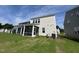 Exterior of a home with a screened porch and lush green lawn on a sunny day at 753 Swim Cave Ln, Wendell, NC 27591