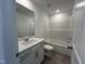 Bright bathroom featuring a white vanity, mirror, and tub/shower combination at 753 Swim Cave Ln, Wendell, NC 27591