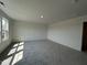 Spacious bedroom with plush gray carpet and a large window providing natural light at 753 Swim Cave Ln, Wendell, NC 27591
