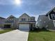 Newly constructed two-story home with a neutral color scheme, two-car garage, and concrete driveway at 753 Swim Cave Ln, Wendell, NC 27591