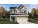 Charming two-story home showcases stone accents, a two-car garage, and meticulous landscaping at 753 Swim Cave Ln, Wendell, NC 27591