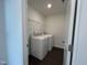 Laundry room equipped with a washer, dryer, and wire shelving at 753 Swim Cave Ln, Wendell, NC 27591