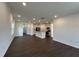 Open-concept living room featuring hardwood floors, white walls, and recessed lighting at 753 Swim Cave Ln, Wendell, NC 27591